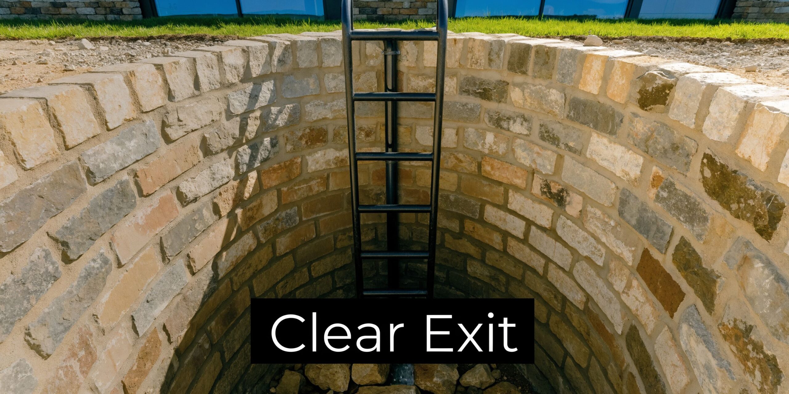 A black metal egress ladder installed against a semicircular brick well, ensuring safety for basement window exits.