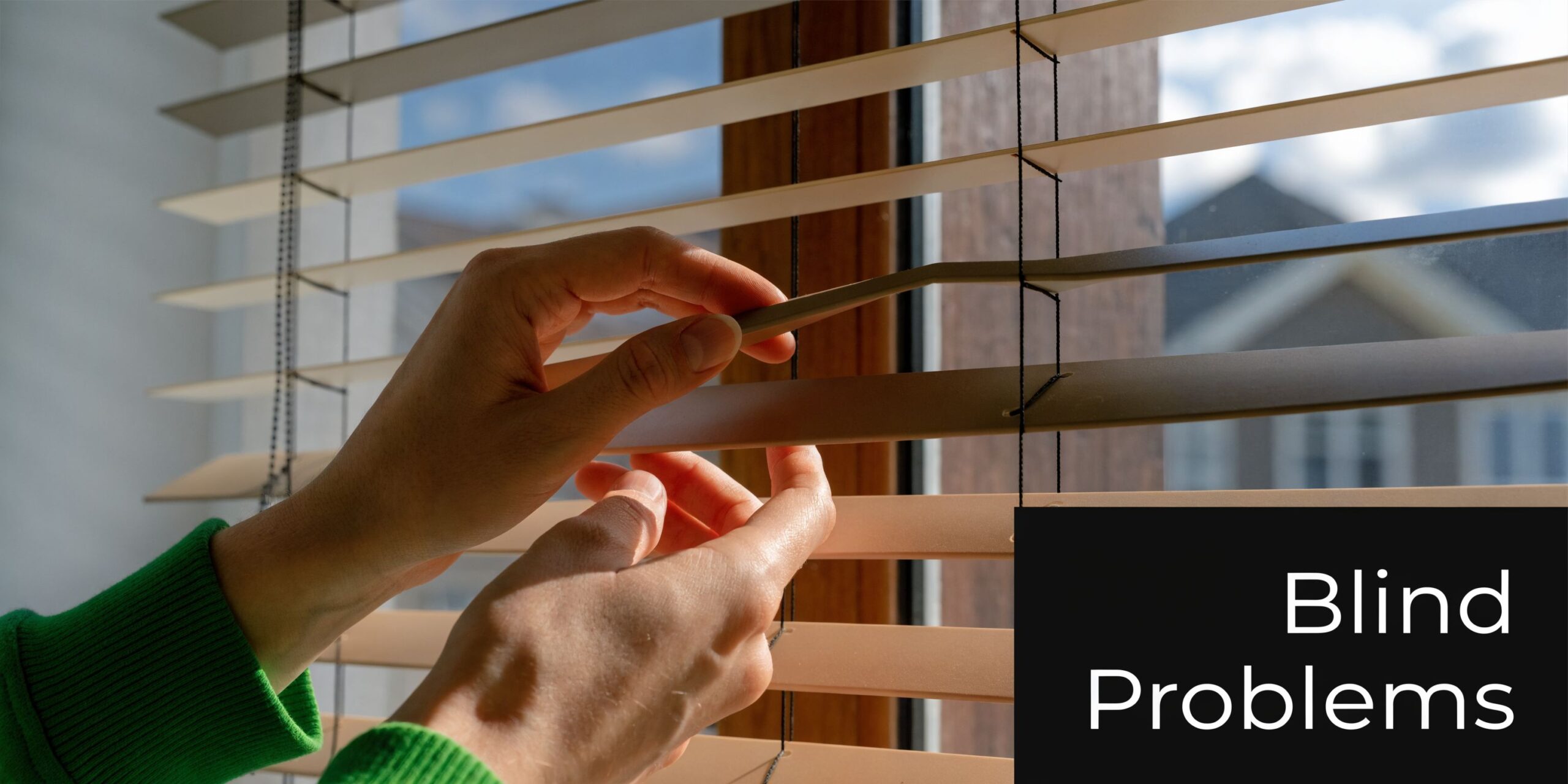A pair of hands adjusting horizontal window blinds, showcasing a common household maintenance issue or repair.