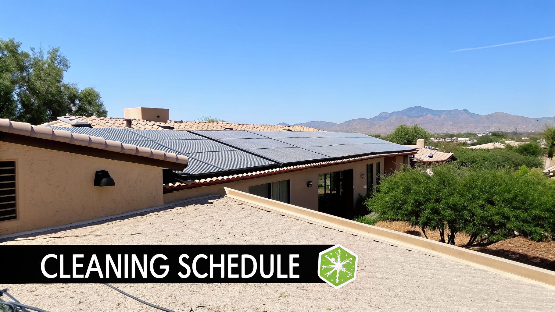 Solar panels on a house roof with a 'CLEANING SCHEDULE' text, distant mountains, and trees.